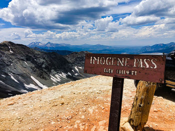 Information sign on landscape against sky