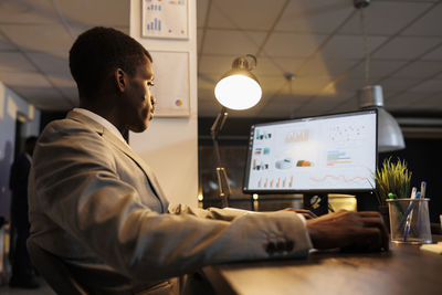 Side view of man working at office