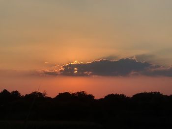 Scenic view of silhouette trees against romantic sky at sunset