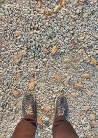 Low section of man standing on stones