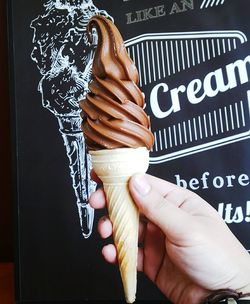 Close-up of hand holding ice cream