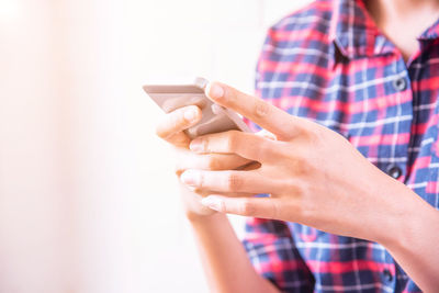 Close-up of hands using mobile phone