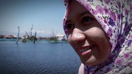 Portrait of woman in pink water against sky