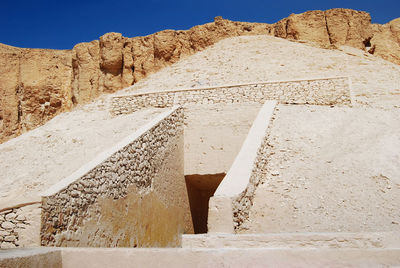 Cobblestone street in desert against clear sky