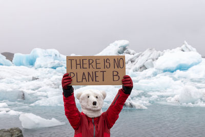 Activist on polar bear mask with a message there is no planet b in icelandic glaciers