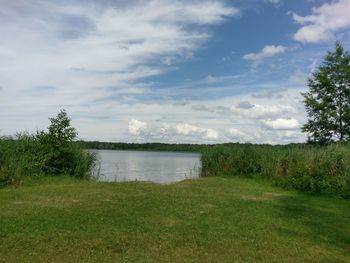 Scenic view of lake against cloudy sky