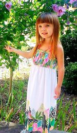 Portrait of smiling girl standing against tree