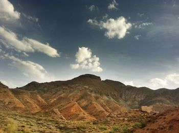 Scenic view of mountains against cloudy sky