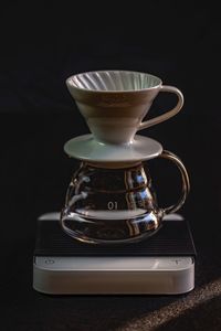 Close-up of coffee cup against black background