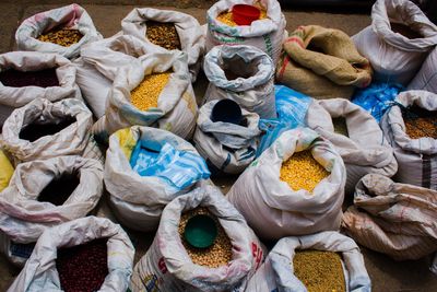 High angle view of various raw food in sack at market for sale