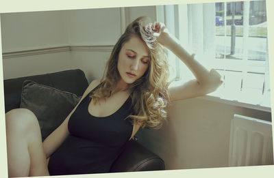 Portrait of woman sitting at home