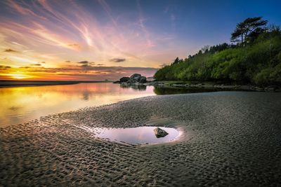 Scenic view of beach at sunset