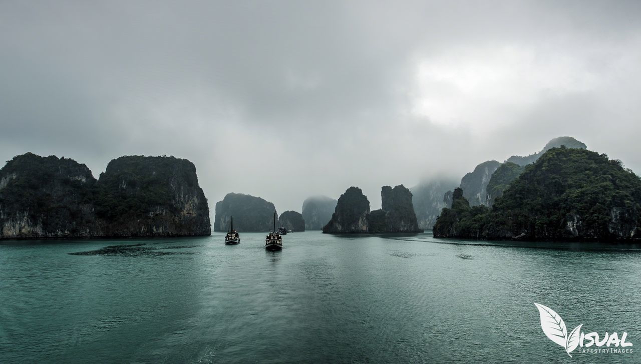 SCENIC VIEW OF SEA WITH MOUNTAINS IN BACKGROUND