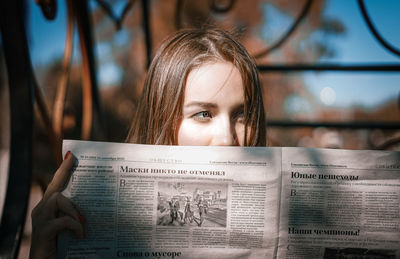 Portrait of young woman reading book