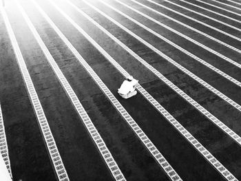 High angle view of man praying on striped flooring outside mosque