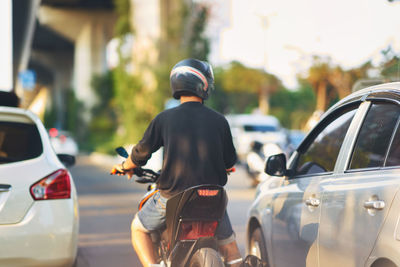 Rear view of man on street in city