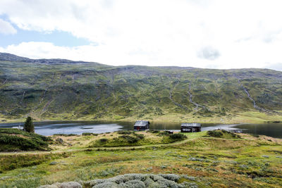 Scenic view of land and mountains against sky