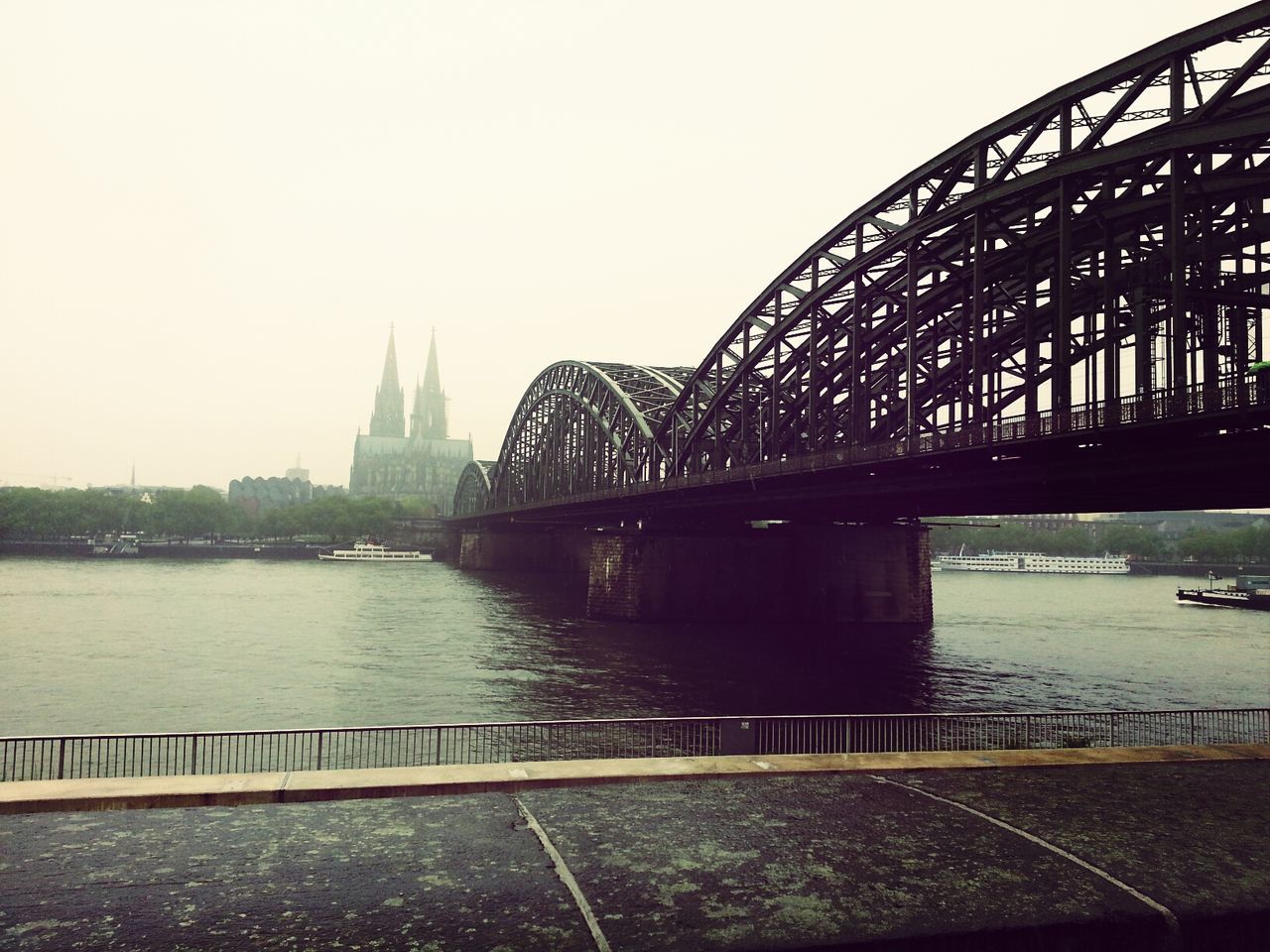 architecture, built structure, connection, bridge - man made structure, water, river, famous place, international landmark, travel destinations, building exterior, tourism, engineering, capital cities, clear sky, travel, bridge, city, transportation, sky, eiffel tower