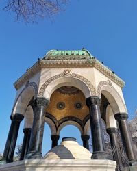 Low angle view of historic building against clear blue sky