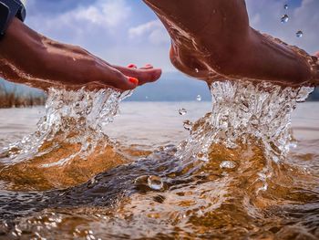 Close-up of hand splashing water