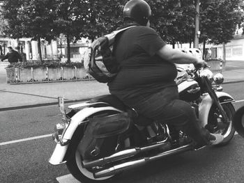 Man riding motorcycle on road