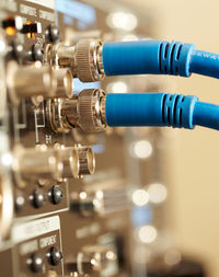 Close-up of blue cables connected to amplifier