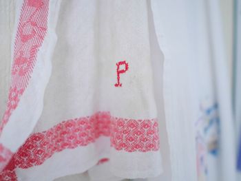 Close-up of alphabet p on white towel hanging in kitchen