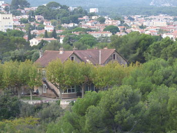 High angle view of townscape and trees in town