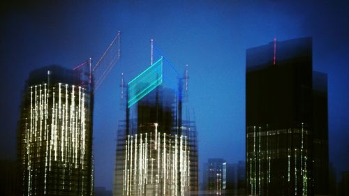 Low angle view of modern building against blue sky