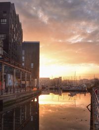 Remote boats moored in harbor at sunset