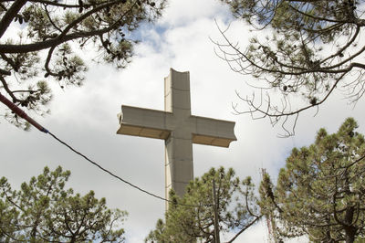 Low angle view of cross against sky