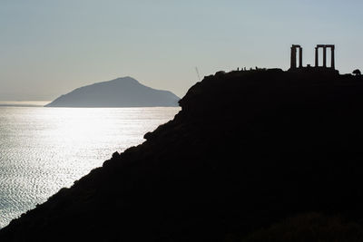 Silhouette of ancient temple on cliff