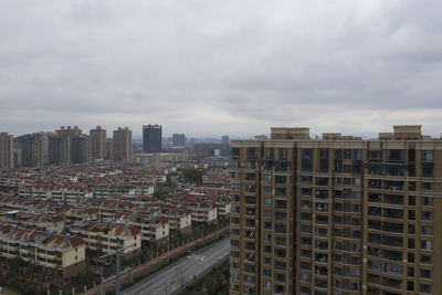 High angle view of buildings in city against sky