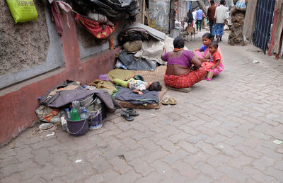 High angle view of people sitting on street at market