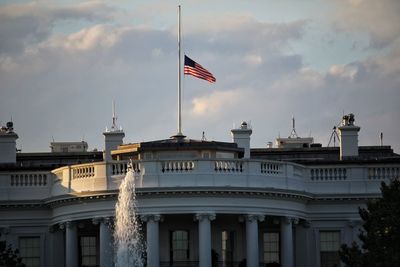 Low angle view of flags against sky in city