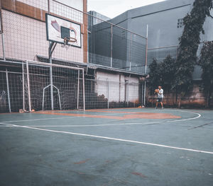 Young man playing basketball court