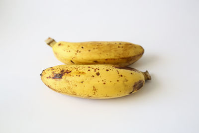 Close-up of bananas against white background