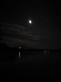 Scenic view of lake against sky at night