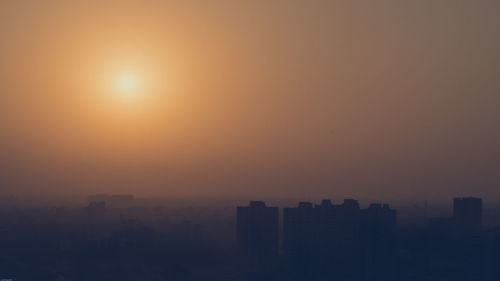 Silhouette of city at sunset