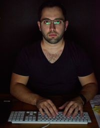 Portrait of man using laptop at home