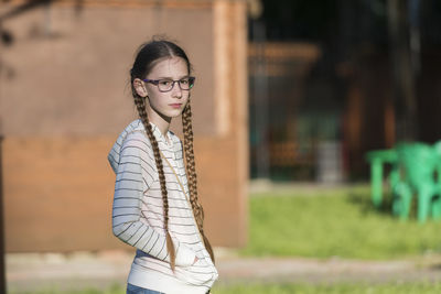 Portrait of young woman standing outdoors