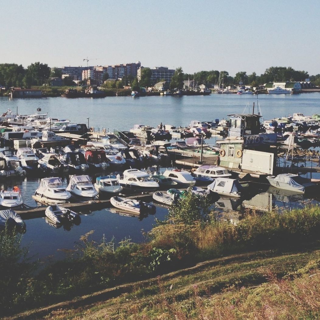 water, nautical vessel, transportation, building exterior, moored, built structure, boat, architecture, mode of transport, river, harbor, city, clear sky, sea, sky, high angle view, lake, day, outdoors, cityscape