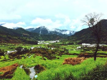 Scenic view of mountains against cloudy sky