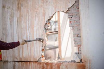 Man working on wood against wall