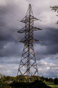 Low angle view of electricity pylon against sky