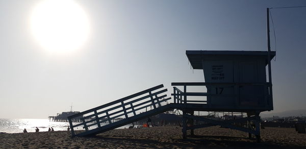 Lifeguard hut on beach against clear sky