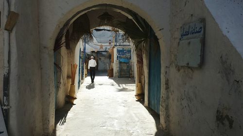 Rear view of woman walking in corridor