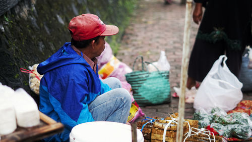 Man sitting at market stall