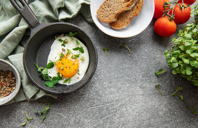 Delicious gourmet breakfast. rye bread with fried egg, freshly ground pepper and salad 