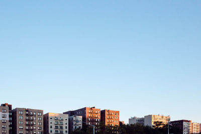 Low angle view of buildings against clear blue sky